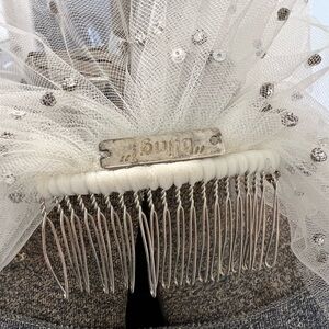 White bridal veil with rhinestones along with comb attachment.